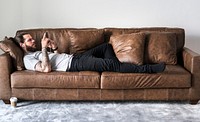 Caucasian man listening to music on a couch