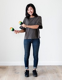 Asian ethnicity girl playing macaras