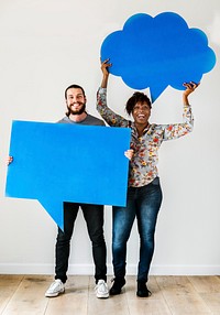 Happy interracial couple holding copyspace speech bubble