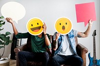 Friends holding an expressive emoticon faces and speech bubbles