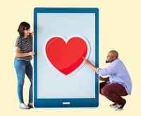 Diverse couple of people holding a tablet