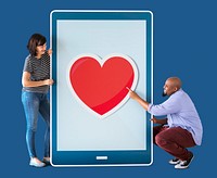 Diverse couple of people holding a tablet