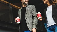 Couple having take away coffee together