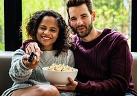 Couple watching tv on the sofa