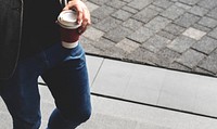 Person holding hot coffee cup