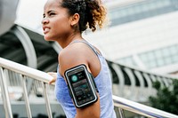Healthy woman exercising while using technology