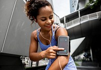 Healthy woman exercising while using technology
