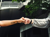 Athletes fist bump together outdoors