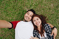Couple taking a selfie in the grass
