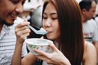 Woman having asian dessert outdoors