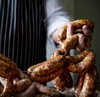 A chef preparing sausages food photography recipe idea
