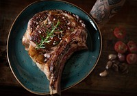 Tomahawk on a plate with garnish food photography recipe idea