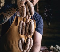 Butcher selling sausages on a string