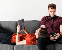 Antisocial couple relaxing on the sofa