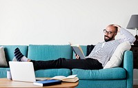 Bearded man reading on the couch