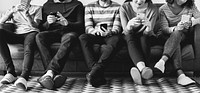 Group of people using mobile phone on couch