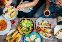 Diverse people eating food together