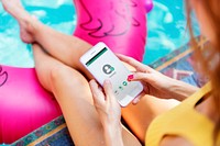 Girl using mobile phone by the pool