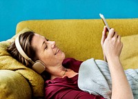 Woman listening to music on the sofa