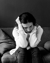 Stressed teenager sitting on a sofa