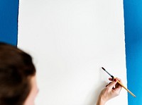 Painter start drawing on a blank canvas