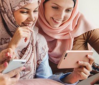 Group of Muslim women talking and watching on the phone together