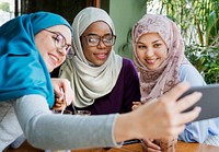 Islamic women friends taking selfie together