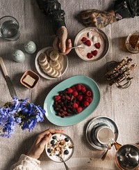 Women enjoying berries and yogurt for breakfast
