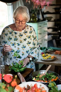Elderly woman cooking in a kitchen