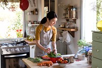 Asian woman busy cooking in the kitchen