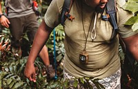 Man trekking in the forest with friends