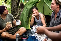 Group of diverse friends camping in the forest