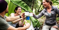 Group of diverse friends camping in the forest