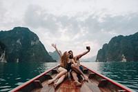 Couple taking selfie on a longtail boat