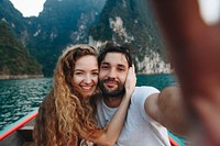 Couple taking selfie on a longtail boat