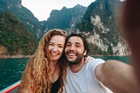 Couple taking selfie on a longtail boat