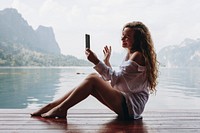 Woman by the water using her phone