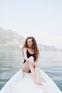 Woman relaxing on a canoe at a lake