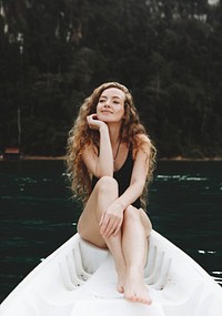 Woman relaxing on a canoe at a lake