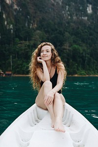 Woman relaxing on a canoe at a lake