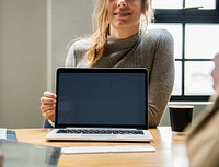 Happy woman with a blank laptop screen