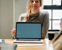 Happy woman with a blank laptop screen