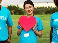 Happy Japanese volunteer with a heart
