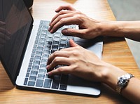 Woman typing on a laptop