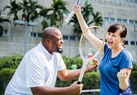 Couple playing tennis as a team