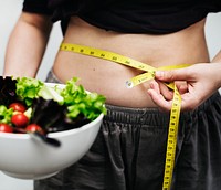 Woman measuring her tummy and weight