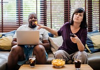 Couple watching tv on the sofa