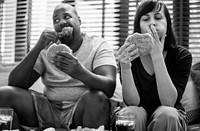 Couple having fast food on the couch