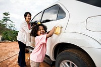 Family washing their white car