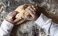Hands of a child kneading dough in the kitchen